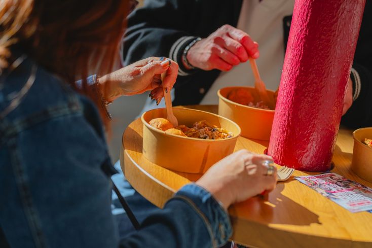 People eating Potful of Caribbean food